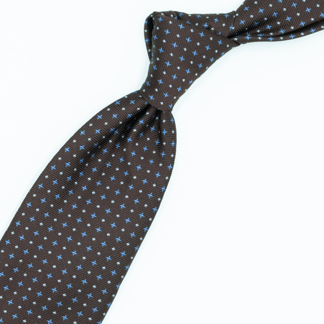 Brown tie with blue crosses and white dots