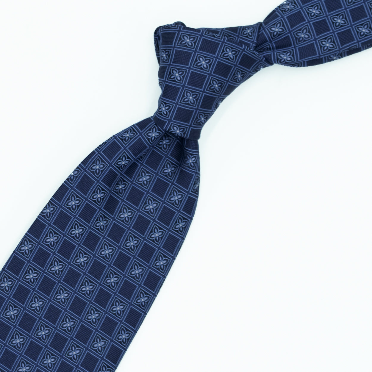 Blue tie with blue flowers and white dots