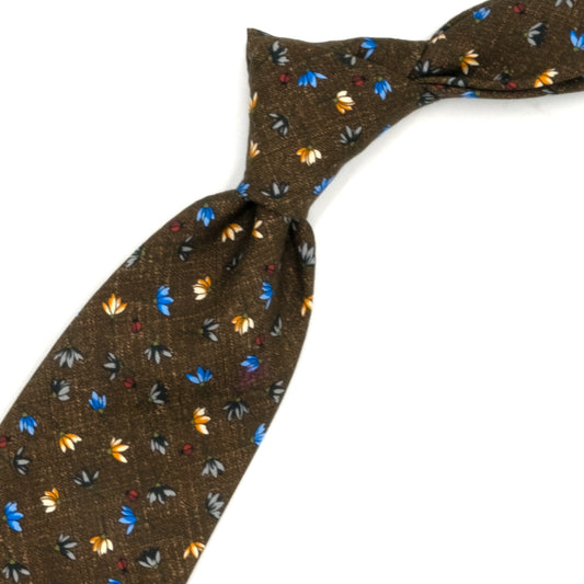 Brown tie with blue, gray and beige flowers