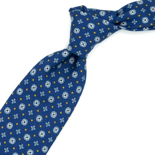 Blue tie with blue flowers and medallions and yellow squares