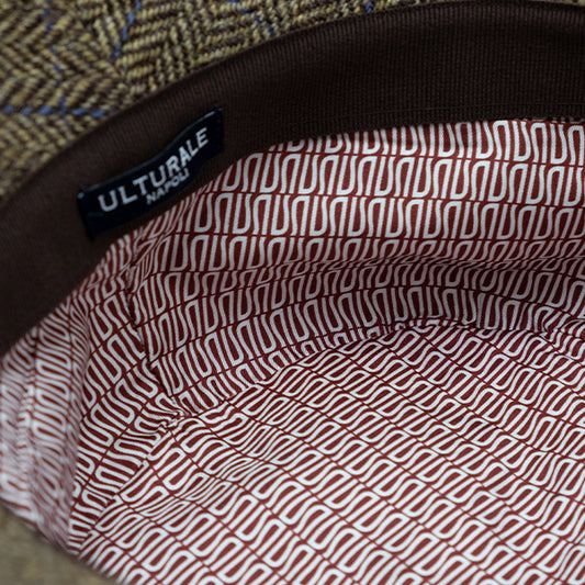 Brown herringbone patterned wool cloche with Ulturale burgundy patterned silk lining