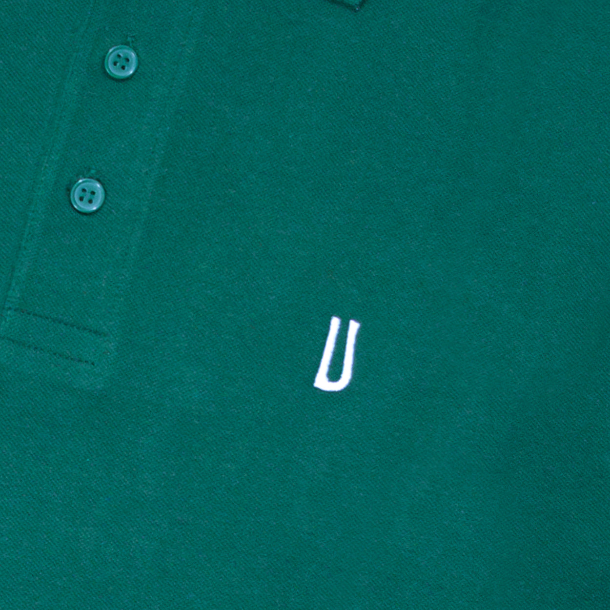 Green polo shirt with white Ulturale logo