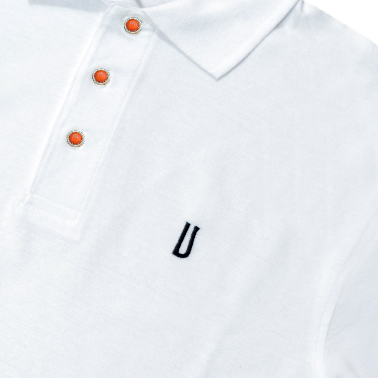 White polo shirt with coral and silver buttons